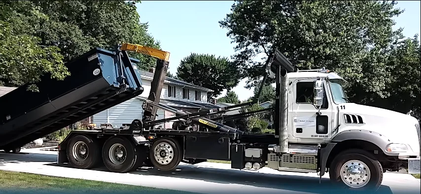 Roll-off dumpster delivery being lowered at an Elgin area jobsite