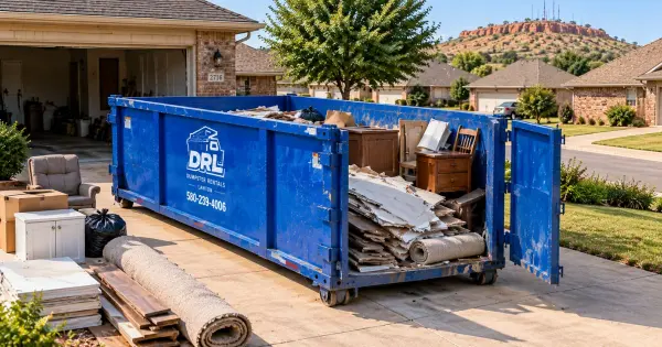 20 yard dumpster filled with drywall, flooring, cabinets, furniture, boxes, and household renovation debris in Lawton, Oklahoma