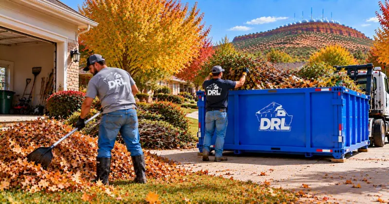 Fall cleanup with leaves, branches, yard debris, and seasonal waste being collected and loaded into a roll-off dumpster in Lawton, Oklahoma