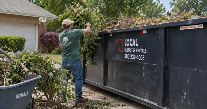 Realistic yard waste disposal with branches and leaves being loaded into a roll-off dumpster in Lawton, Oklahoma